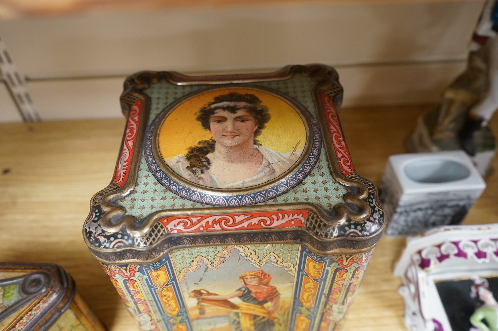 A Windmill biscuit tin by Huntley & Palmer: Reading & London, 'BIVM' Eastern Beauties tea tin and Huntley & Palmers triangular biscuit tin with 'Sports' motifs